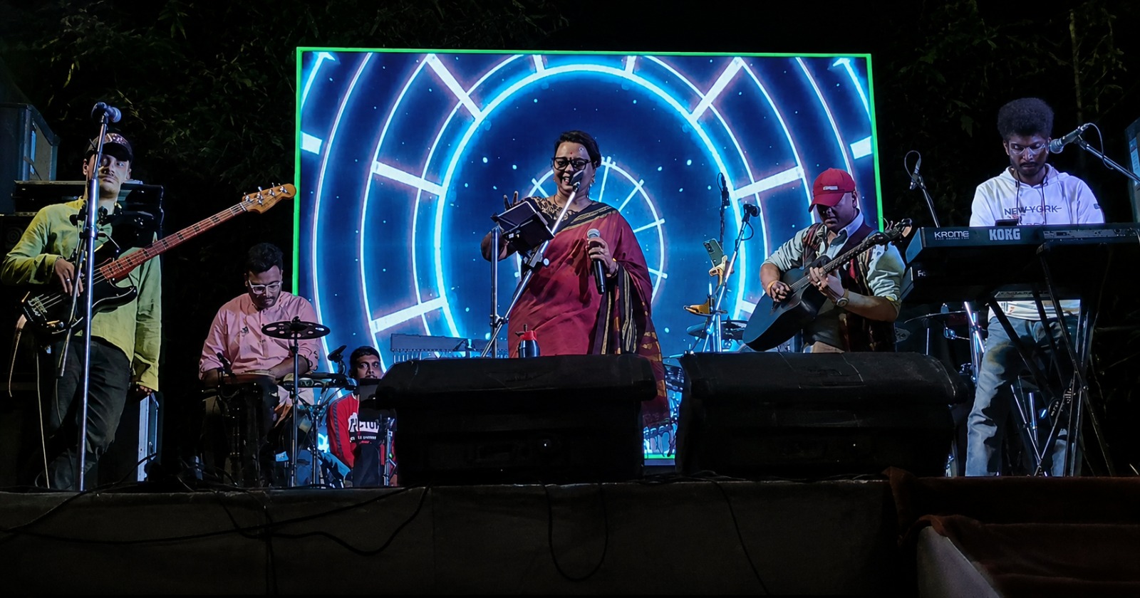A band performing on the Sabai Sangha stage at night